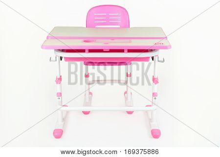 School desk and chair pink color on a white background isolated