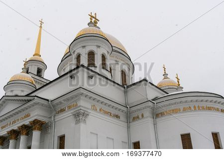 Orthodox temple. Golden domes of Novo-Tikhvinsky women monastery in Ekaterinburg  during snowfall in winter.
