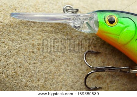 Fishing bait wobbler on a stone sandstone. close up with copy spaсe