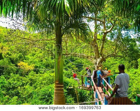 Woman going on a jungle zipline adventure at Antigua rainforest