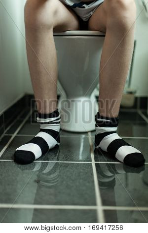 Sitting On A Toilet