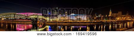 Moscow Russia - January 20 2017: Night winter panorama of the Moskva River embankment: pedestrian bridge Bogdan Khmelnitsky Kiev railway station Moscow-City Redisson Slavyanskaya hotel 