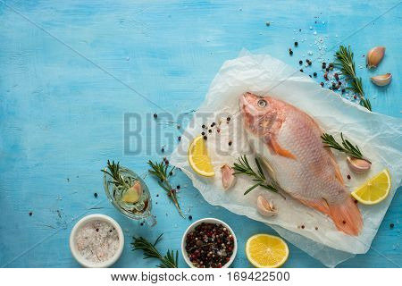 Fresh raw fish tilapia. Nile tiapia Oreochromis niloticus. Top view. Food cooking background.