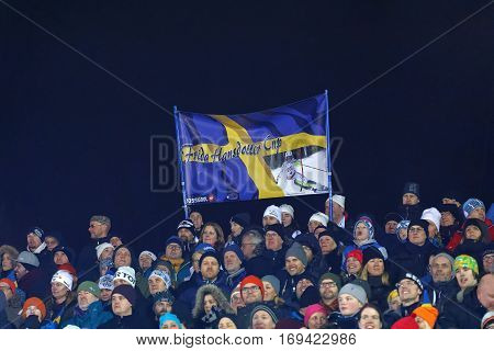 STOCKHOLM SWEDEN - JAN 31 2017: Happy audience with swedish flags in the parallel slalom event at the Alpine Audi FIS Ski World Cup - city event January 31 2017 Stockholm Sweden