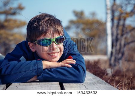 Cute little boy having rest outdoors, Kemeri national park, Latvia