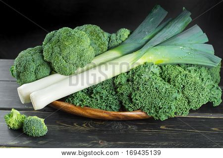 Green winter fresh organic superfood - Kale green cabbage broccoli and leeks prei
