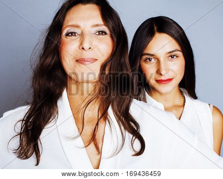 cute pretty teen daughter with mature mother hugging, fashion style brunette, lifestyle people concept close up