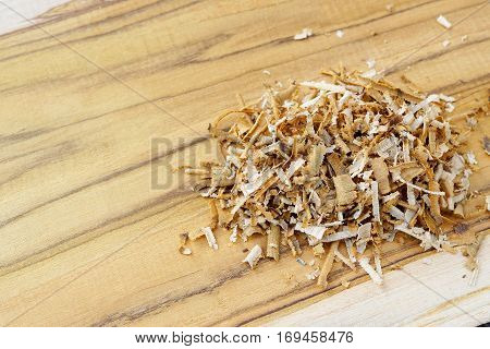 A pile of saw dust on teak wood plank