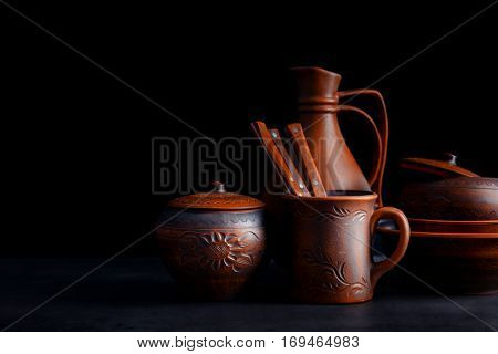 Brown dishware on table and black background