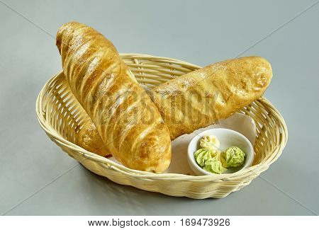 White bread in a basket with sauce