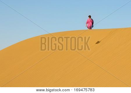 MARANJAB DESERT, iRAN, AUGUST 18, 2016: Woman walking on Sand dunes in the Maranjab desert near Kashan Iran