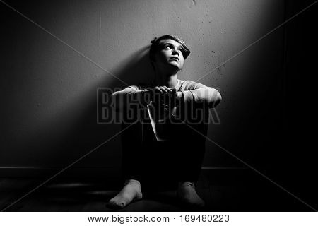 Barefoot Thoughtful Boy Sat Against Wall