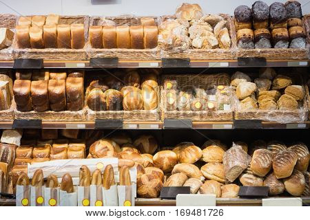 Focus on shelves with bread in a supermarket