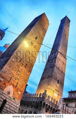 Angle shot of towers Asinelli and Garisenda (12-th century) in Bologna at night, Italy