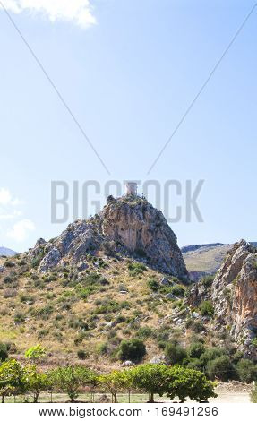 An ancient tower in the mountains can be seen from the town of Scopello as well as the tipical grape trees