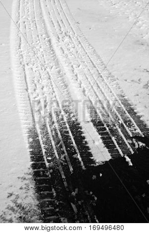 Road roadway with snow and ice car tracks slippery