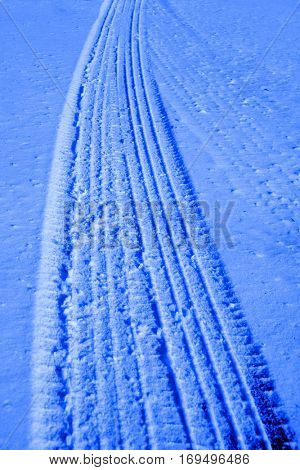 Road roadway with snow and ice car tracks slippery