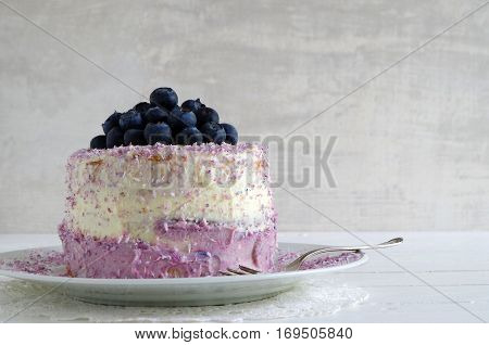 fresh home made bluebarry cake with purple cream cheese and coconut flake
