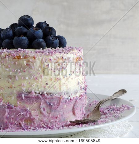 fresh home made bluebarry cake with purple cream cheese and coconut flake