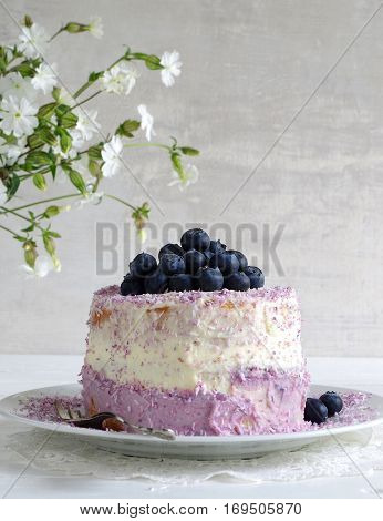fresh home made bluebarry cake with purple cream cheese and coconut flake