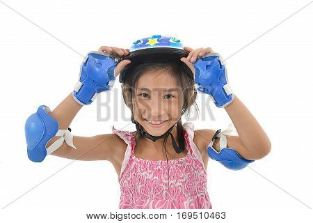 Happy Asian girl wearing hand and headguard for playing rollerskates on white.