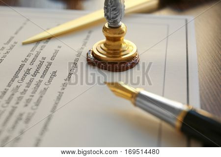 Stamping old notarial wax seal on document