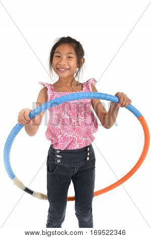 Portrait of happy little Asian child girl playing hulahoop on isolated white background