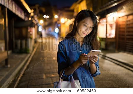 Woman use of mobile phone at night