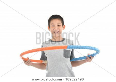 Asian boy playing with the hulahoop on a white background