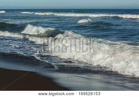Khalaktyrsky beach with black sand. Pacific Ocean washes the Kamchatka Peninsula.
