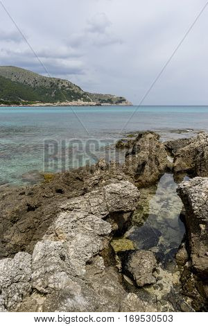 Rocks by the Mediterranean sea on the island of Ibiza in Spain, holiday and summer scene