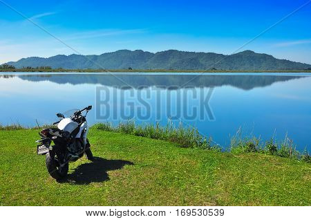 Bigbike Beside The Reservoir And Mountain Background