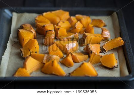 roasted pumpkin slices on a baking sheet