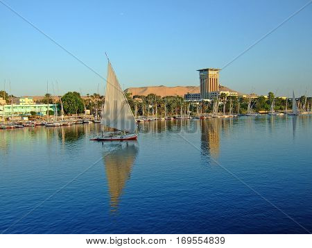 The River Nile with boats and felluca's sailing along the river taking tourists on their trip along the Nile in Egypt