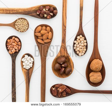 Different Kind Of Beans And Lentils In Wooden Spoon On White Wood Background. Mung Bean, Groundnut,