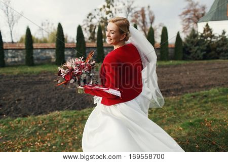 Smiling Bide In Red Jacket Turns Around Holding An Autumn Bouquet