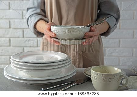 Female hands holding porcelain dishware, closeup