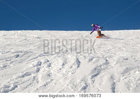 Stylysh beginner snowboarder man in caucasian mountains