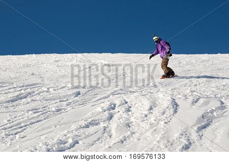 Stylysh beginner snowboarder man in caucasian mountains