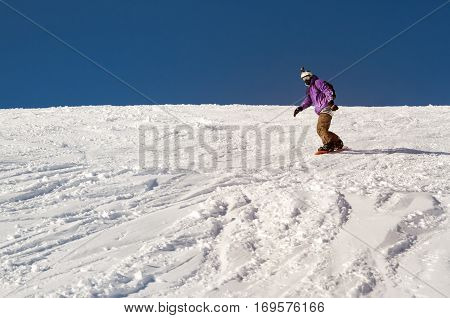 Stylysh beginner snowboarder man in caucasian mountains