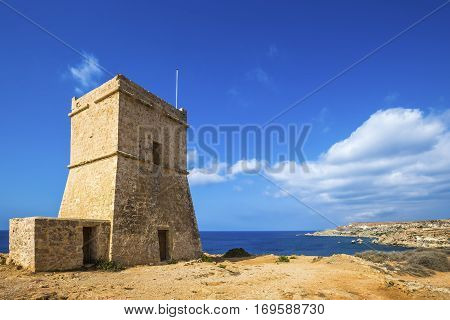 Malta - Ghajn Tuffieha watchtower at Golden Bay on a nice sunny summer day with clear blue sky