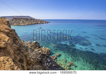 Malta - Ghajn Tuffieha bay view on a nice summer day with crystal clear sea water and blue sky