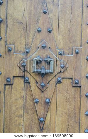 Old and worn wooden door in the town of Valldemosa in the Balearic Islands Spain