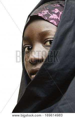 Vertical Little Young African School Girl Posing Outdoors Veiled by a Black Niqab