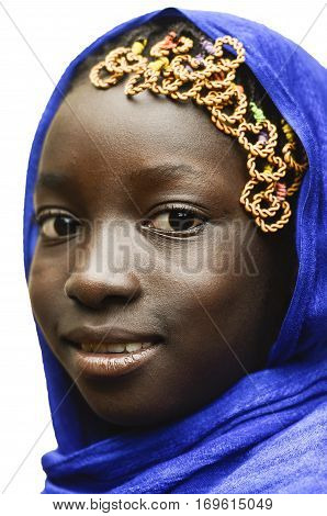 Gorgeous Smiling African Schoolgirl Veiled by a Blue Typical African Clothing