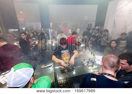 Moscow, Russia - December 9, 2016: People attend Vapexpo Moscow 2016 exhibition which presents new modern vape gadgets, liquids and flawours