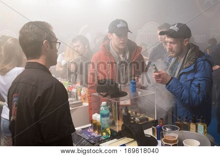 Moscow, Russia - December 9, 2016: People attend Vapexpo Moscow 2016 exhibition which presents new modern vape gadgets, liquids and flawours