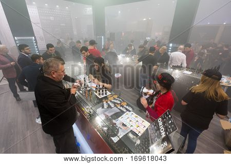 Moscow, Russia - December 9, 2016: People attend Vapexpo Moscow 2016 exhibition which presents new modern vape gadgets, liquids and flawours
