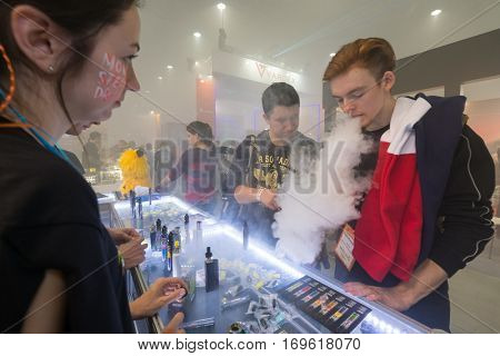 Moscow, Russia - December 9, 2016: People attend Vapexpo Moscow 2016 exhibition which presents new modern vape gadgets, liquids and flawours