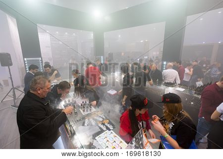 Moscow, Russia - December 9, 2016: People attend Vapexpo Moscow 2016 exhibition which presents new modern vape gadgets, liquids and flawours